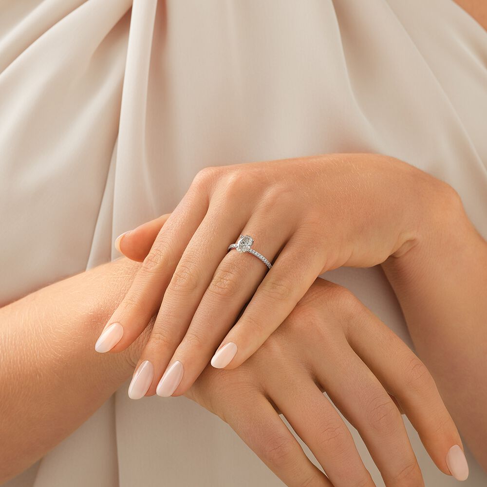 Engagement Ring with 1.14 Carat TW of Diamonds. A 1 Carat Oval Centre Laboratory-Grown Diamond and shouldered by 0.14 Carat TW of Natural Diamonds in 14kt White Gold